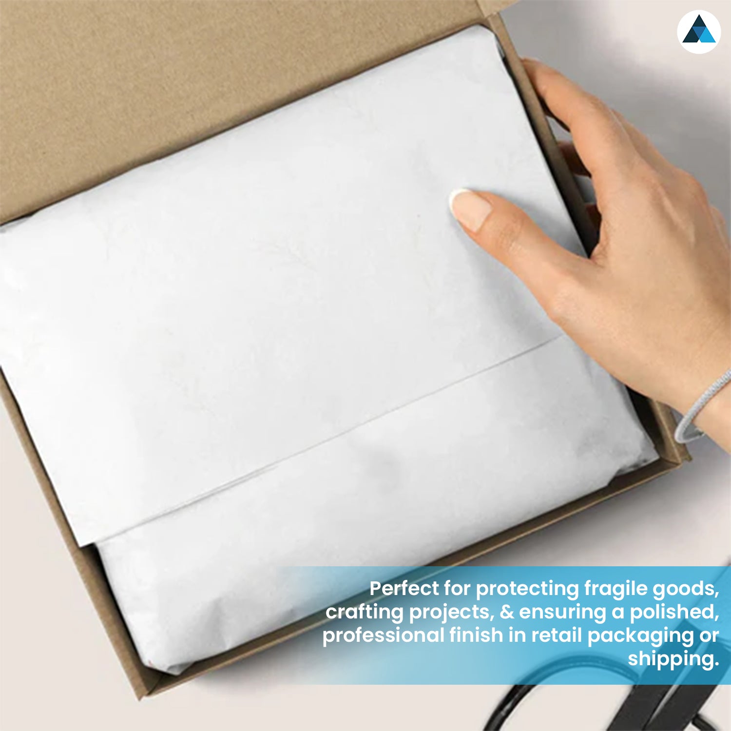 White fabric in a cardboard box with a hand holding it, text about protecting fragile goods.